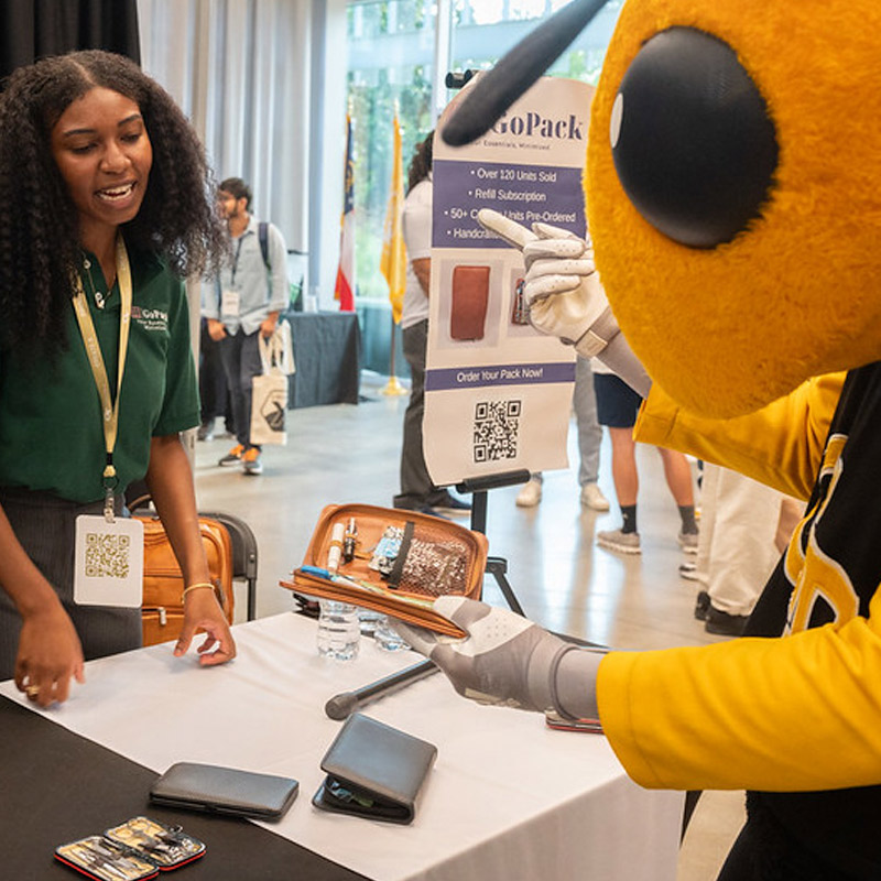 Student and Georgia Tech Mascot, Buzz, at a Create-X Event