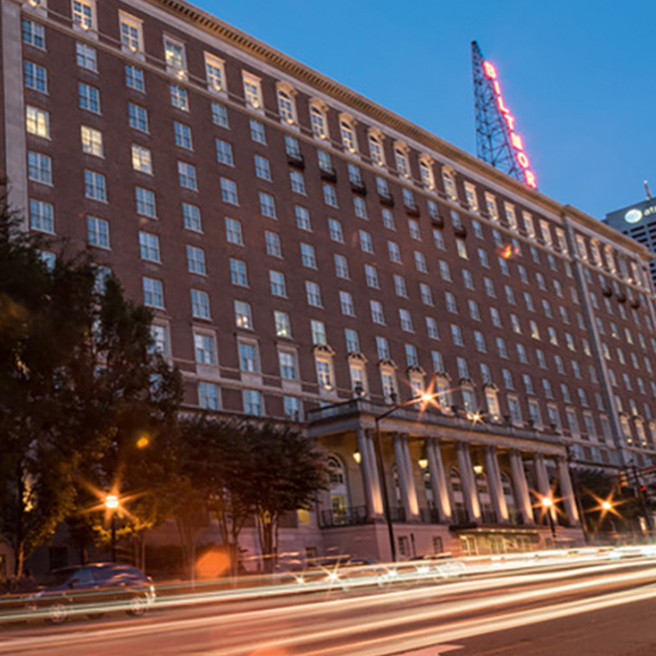 Picture of Biltmore Hotel and street in front, with car light streams